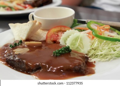 A Plate Of Beef Steak With Pepper Gravy