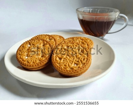 a plate of biscuits accompanied by a cup of tea in a white background photo studio. concept, breakfast,appetizer,dipping, appetizing, coconut, savory, Snack, baked, food and drink, 