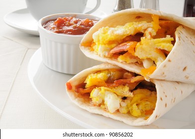 A plate of breakfast burritos with salsa