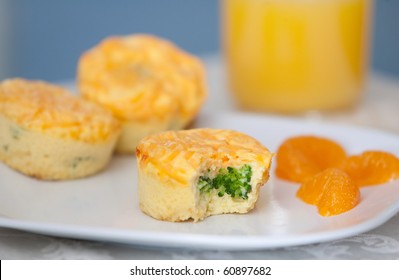 Plate Of Breakfast Egg And Broccoli Muffins With Cheese On A White Plate