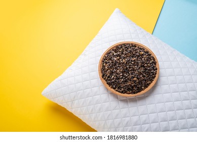 A Plate Of Buckwheat Husks And A White Pillow