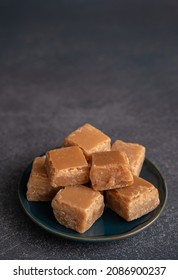 Plate of Butterscotch Fudge from Above on a Dark Background with Copy Space