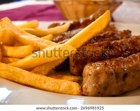 Plate of - Cevapi - Serbian traditional BBQ food, served with french fries. 