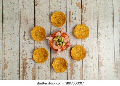 
Plate Of Ceviche With Avocado, Shrimp And Patacones On A Rustic Table. Overhead View