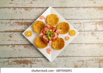 Plate Of Ceviche With Avocado, Shrimp And Patacones On A Rustic Table. Overhead View. 
Exotic Gastronomy Concept