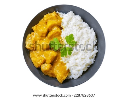 plate of chicken with curry sauce and rice isolated on white background, top view