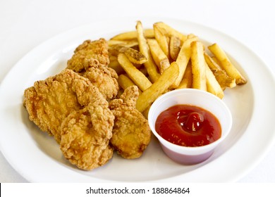 A Plate With Chicken Tenders And French Fries.