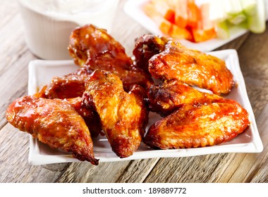 Plate Of Chicken Wings On Wooden Table