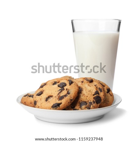 Plate with chocolate chip cookies and glass of milk on white background