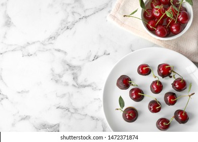 Plate of chocolate dipped cherries on white marble table, flat lay. Space for text - Powered by Shutterstock