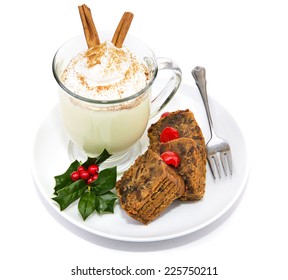 Plate Of Christmas Fruitcake And Delicious Frothy Eggnog Isolated On White.