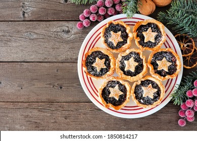 Plate Of Christmas Mincemeat Tarts. Top Down View Table Scene Over A Dark Wood Background.