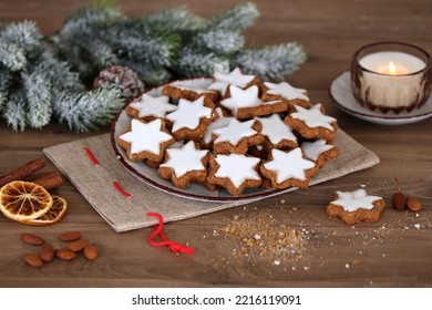 Plate of cinnamon stars on a wooden table.