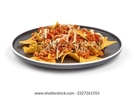 Plate of corn chips nachos with fried minced meat and cheese, isolated on white background