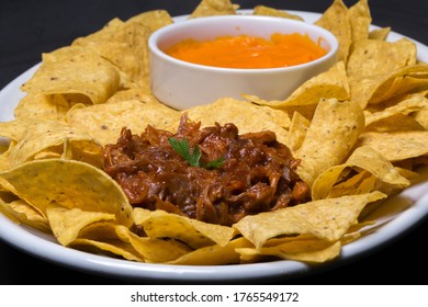 Plate Of Corn Chips Nachos With Shredded Meat And Cheddar Cheese