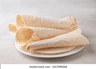 Plate with corn tortillas on table. Unleavened bread