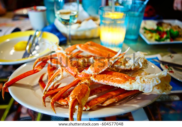 Plate with crab legs in a restaurant\
in Key West or New Orleans. Tasty delicious\
seafood.