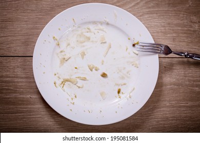 Plate With Crumbs Food And Used Fork 