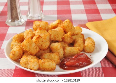 A Plate Of Deep Fried Tater Tots With Catsup