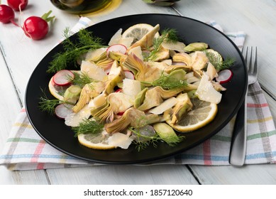 Plate of delicious artichoke salad with radish, parmigiano and extra virgin olive oil, Italian food  - Powered by Shutterstock