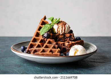 Plate of delicious Chocolate Belgian Waffles with ice cream and blueberry on table