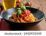 Plate of delicious classic tomato sauce and basil spaghetti, italian pasta, mediterranean diet 