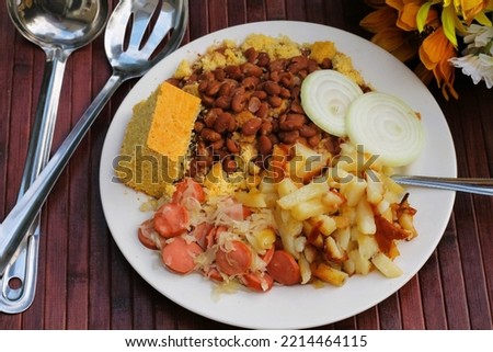 A plate of delicious, comfort food, that has been served in the Appalachian Mountains for many years.  It includes pinto beans, cornbread, fried potatoes, sauerkraut and weiners, with some slices of o
