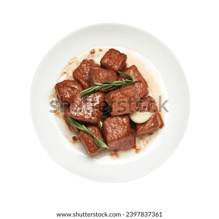 Plate with delicious cooked beef, garlic and rosemary isolated on white, top view. Tasty goulash