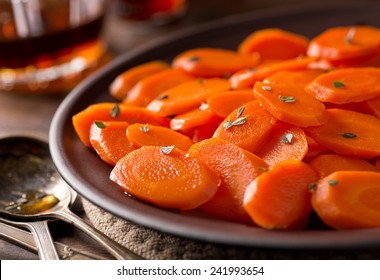 A Plate Of Delicious Maple Glazed Carrots With Thyme.