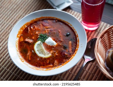 Plate of delicious meat soup of Russian cuisine Solyanka with sour cream - Shutterstock ID 2195625485