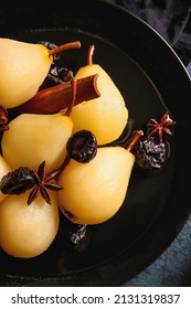 Plate with delicious poached pears and prunes on table, closeup