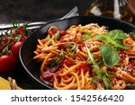 Plate of delicious spaghetti Bolognaise or Bolognese with savory minced beef and tomato sauce garnished with parmesan cheese