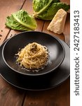 Plate of delicious spaghetti with cacio, black pepper and savoy cabbage sauce, vegetarian italian pasta, european food 