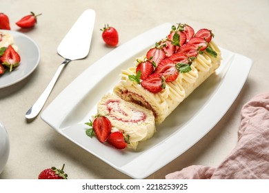 Plate With Delicious Strawberry Roll Cake On Table