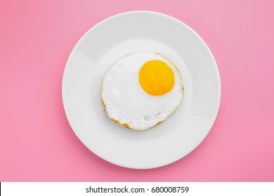 Plate With Delicious Sunny Side Up Egg On Colour Background