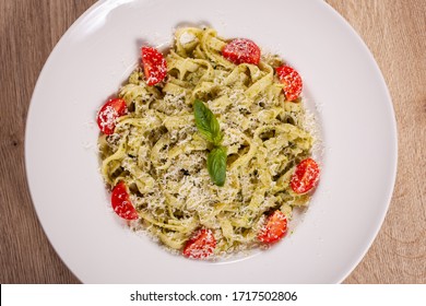  Plate With Delicious Tagliatelle Pasta With Pesto Sauce, Parmesan, Cherry Tomatoes And Basil Leafs On White Plate. Top Down View