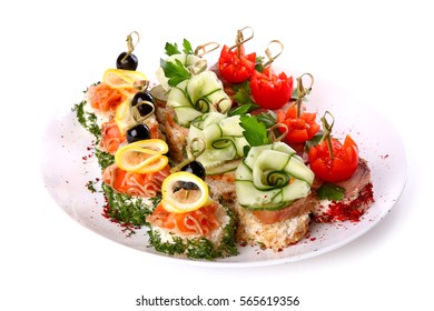 Plate Of Different Canapes Isolated Over White Background