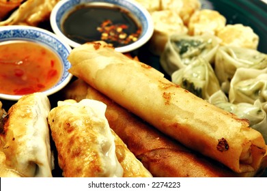 Plate Of Dim Sum, Egg Rolls, Shumai, And Pot Stickers With Dipping Sauce