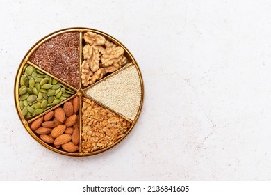 Plate divided into sectors with various seeds and nuts. Concept: vegetarian and vegan food. Natural nutrition