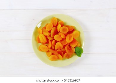 Plate Of Dried Apricots On White Background