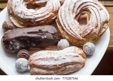 A Plate With Eclairs And Curd Rings