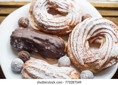 A Plate With Eclairs And Curd Rings