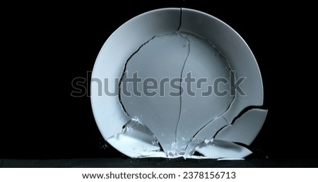 Plate falling and exploding on Black Background