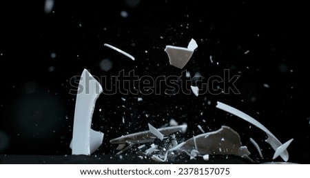 Plate falling and exploding on Black Background