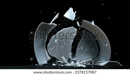 Plate falling and exploding on Black Background