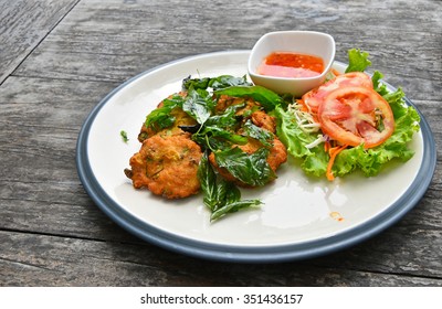 Plate Of Fish And Shrimp Deep Fried Cakes Croquettes Snack With Salad Basil Leaves And Hot Sauce On Vintage Wooden Table Surface