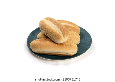 A Plate Of Four Cornmeal Hotdog Buns Isolated On White