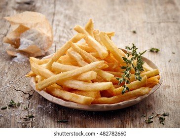 plate of french fries on wooden table