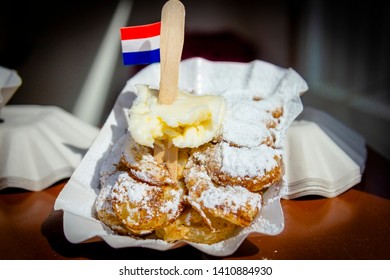 A plate with fresh baked Poffertjes with banana. Poffertjes are a traditional Dutch batter treat