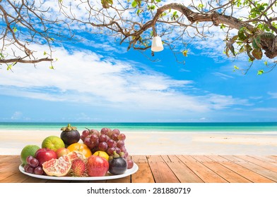 Plate Of Fresh Fruit Put On A Wooden Planks At The Beautiful Beach